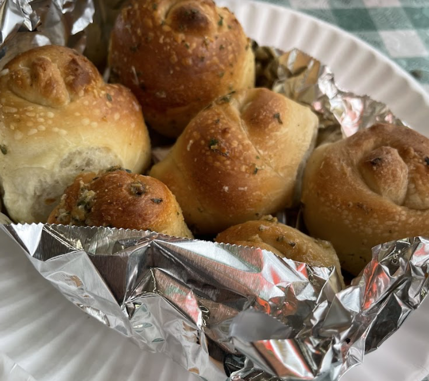 Garlic knots wrapped in foil on a plate